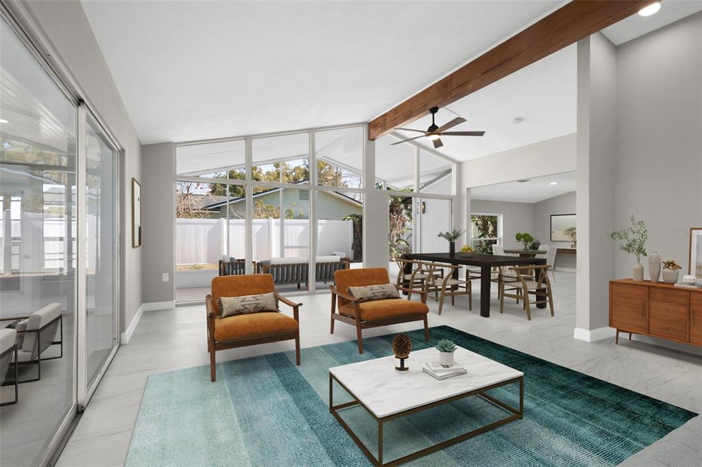 A view from a hallway looking into a living area and a kitchen with stainless appliances — 729 SPANISH MAIN DRIVE, APOLLO BEACH, FL