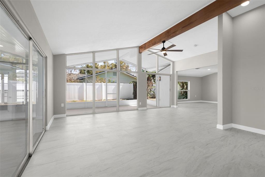 A kitchen with gray cabinets, stainless steel appliances, and white countertops next to a window — 729 SPANISH MAIN DRIVE, APOLLO BEACH, FL