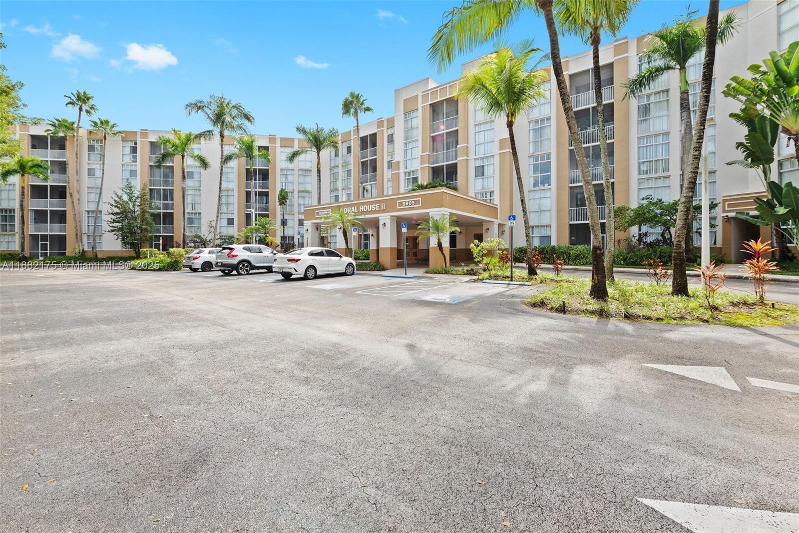 A multi-story apartment building with a covered entrance and a paved parking lot — 9805 NW 52nd St # 216, Doral FL 33178, DORAL, FL