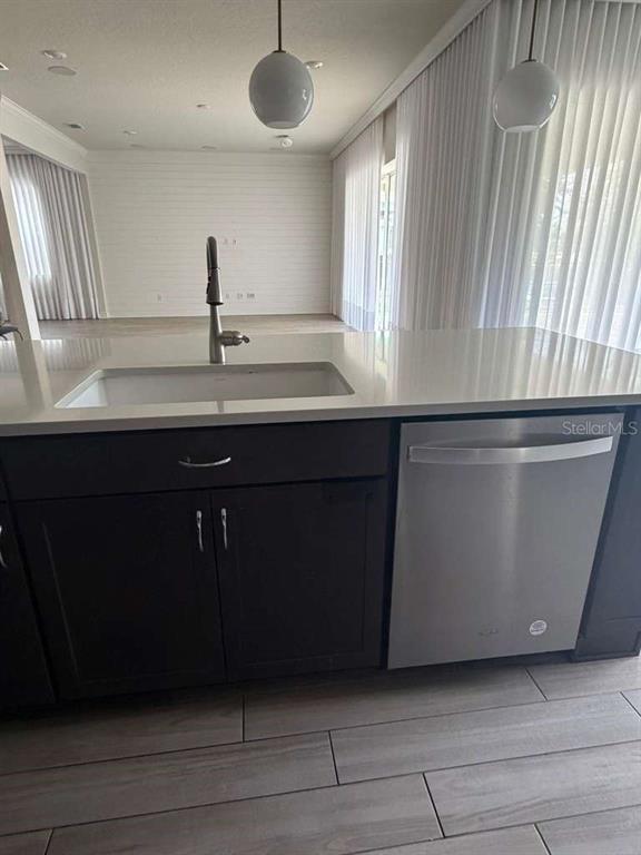 A walk-in pantry features wire shelving, light-colored walls, and wood-look tile flooring — 10732 PAHOKEE BEACH PLACE, ORLANDO, FL