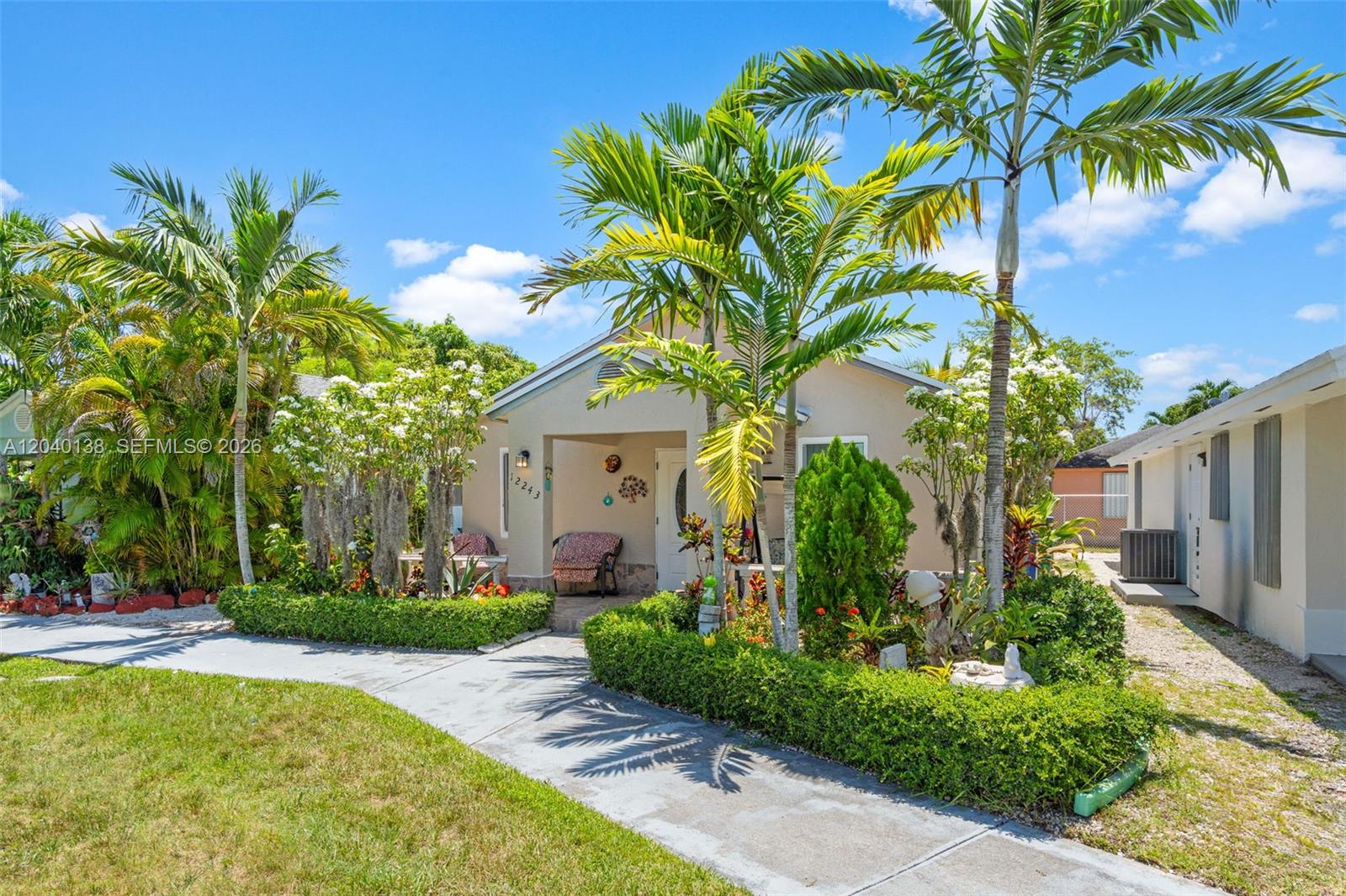 A single-story house with a palm-lined front yard and a concrete walkway — 12243 SW 201st Ter, Miami FL 33177, MIAMI, FL