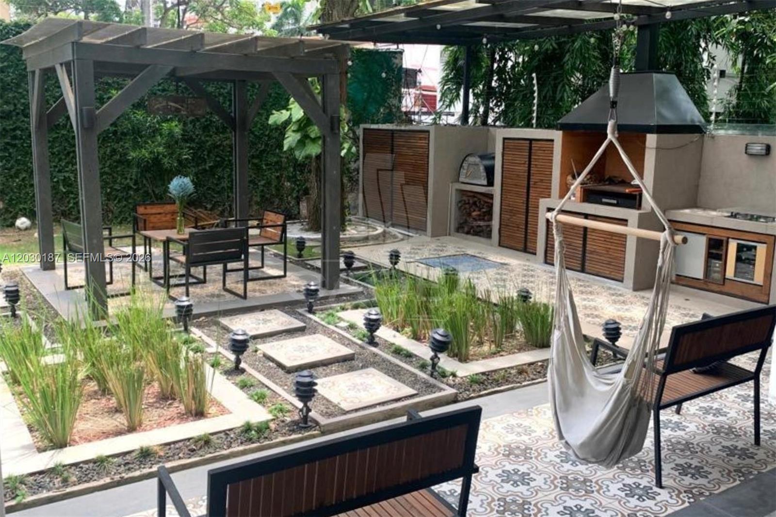 A landscaped outdoor patio features a pergola, dining area, built-in grill, and a hanging chair — 0 MARBELLA Panama Republic of Panama, FL, FL