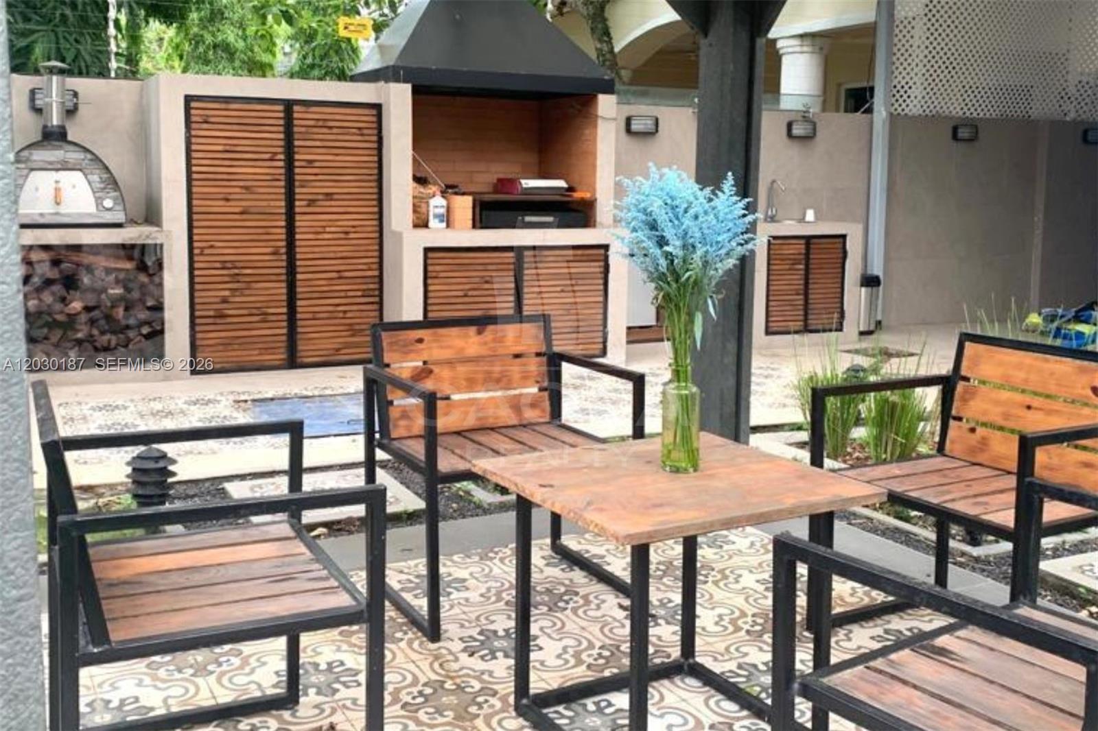 An outdoor patio features a built-in grill, pizza oven, and a wooden dining set — 0 MARBELLA Panama Republic of Panama, FL, FL