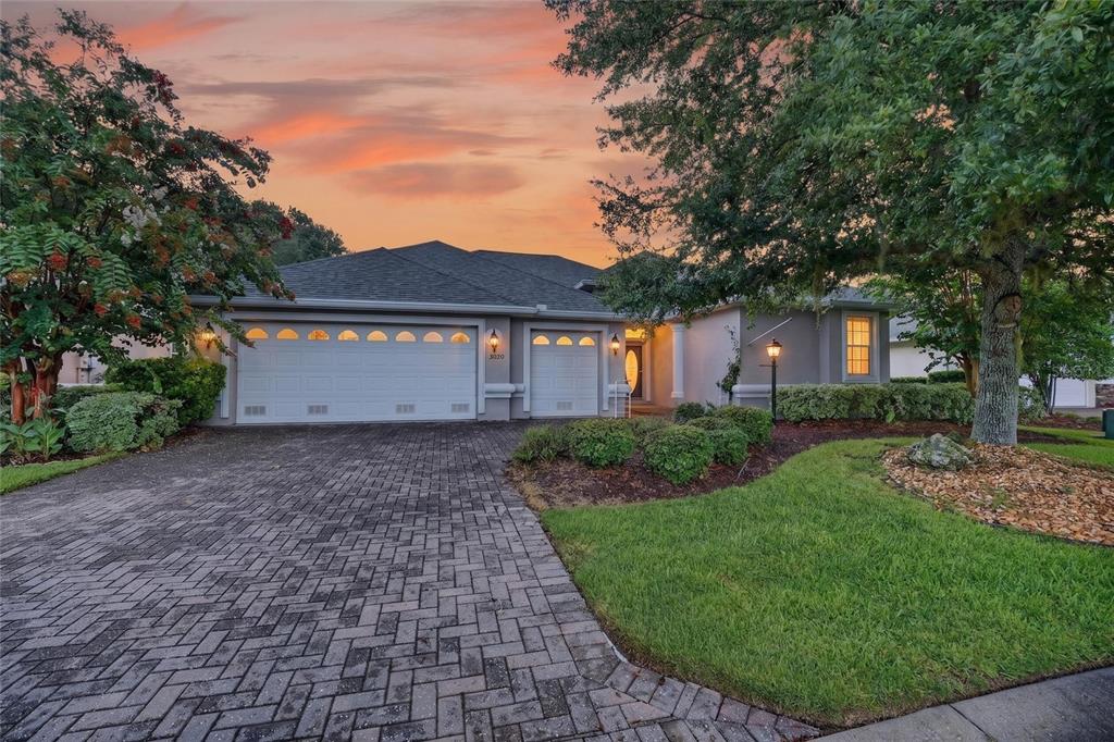 A single-story house with a paved driveway, two garage doors, and a landscaped front yard — 8640 SW 86TH CIRCLE, OCALA, FL