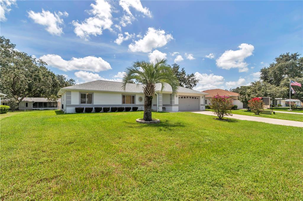 An aerial view of a single-story house with a gray roof and a concrete driveway — 10237 SW 63RD AVENUE, OCALA, FL