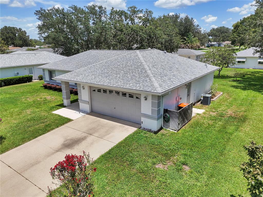 A single-story house with a white exterior, a palm tree, and a green lawn — 10237 SW 63RD AVENUE, OCALA, FL