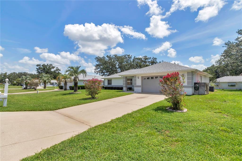 An elevated view of a single-story house with a gray shingled roof and garage — 10237 SW 63RD AVENUE, OCALA, FL