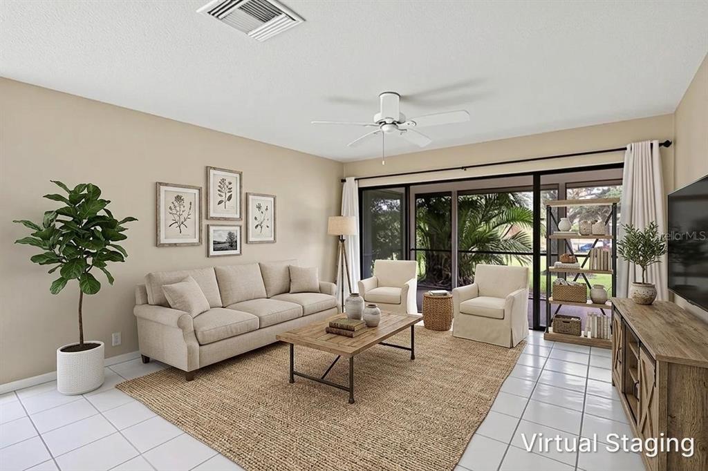 A virtually staged living room features a beige sofa, two armchairs, and a large rug — 6642 SCHOONER BAY CIRCLE UNIT 6642, SARASOTA, FL