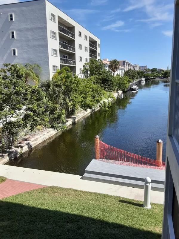 A view of a canal with a small dock and a multi-story apartment building nearby — 1439 S Ocean Boulevard # 217, Pompano Beach FL 33062, POMPANO BEACH, FL