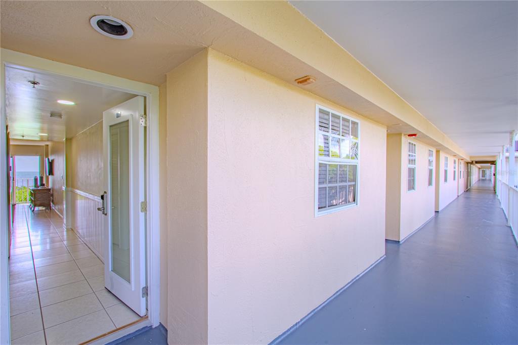 An open door leads from a covered outdoor walkway into a tiled interior hallway — 500 BURTON DRIVE UNIT 4204, TAVERNIER, FL