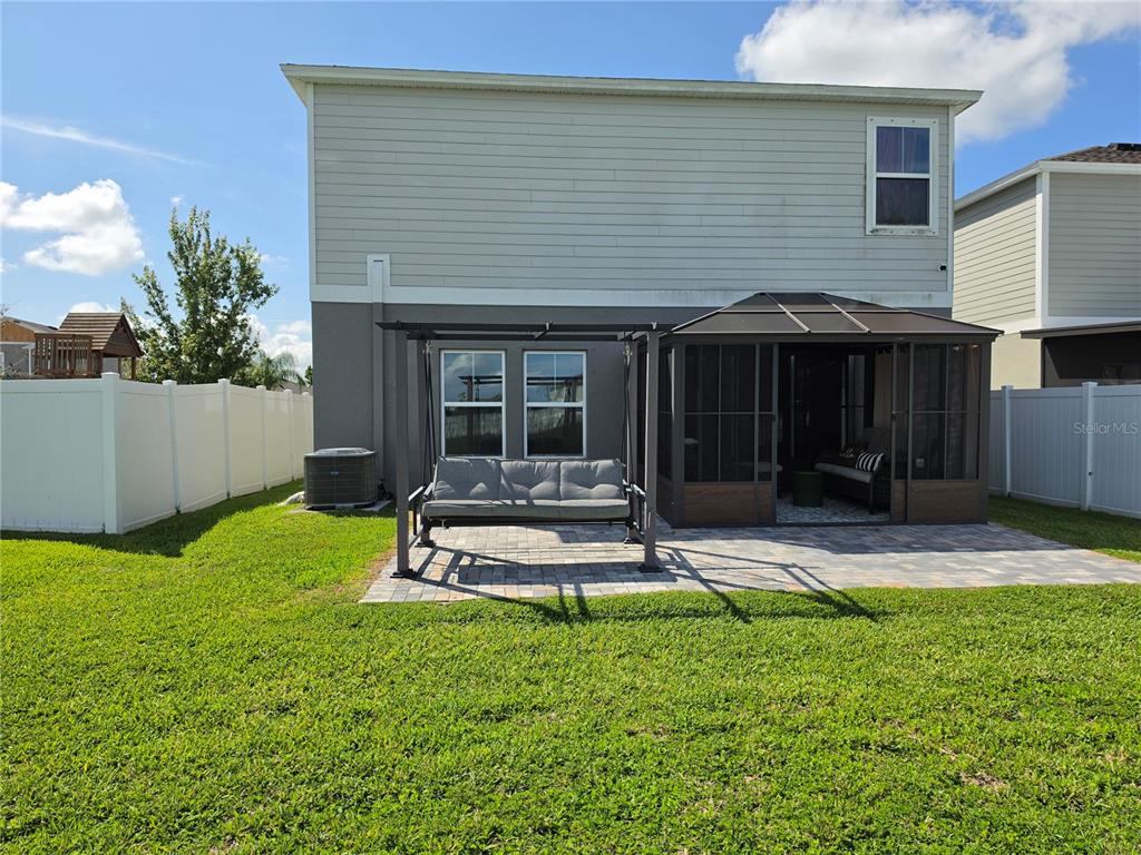 A two-story house with a gray garage, orange accent siding, and a palm tree — 12879 FRENCH MARKET DRIVE, RIVERVIEW, FL
