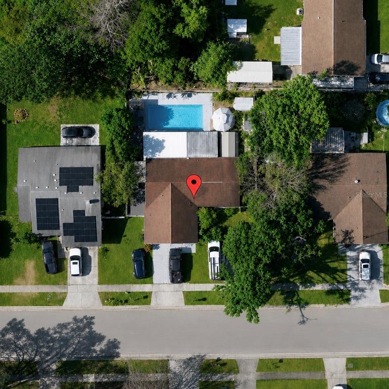 An aerial view shows a residential house with a swimming pool and several parked cars — 1341 FOXWOOD DRIVE, LUTZ, FL