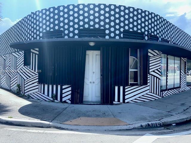 A corner building exterior features a polka-dot upper facade and black-and-white striped lower walls — 5600 NW 7th Ave, Miami FL 33127, MIAMI, FL