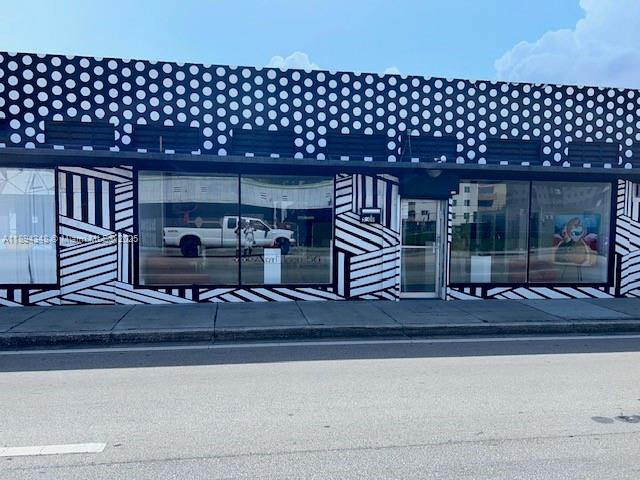 A commercial building exterior features a black and white polka dot pattern and geometric stripes — 5600 NW 7th Ave, Miami FL 33127, MIAMI, FL