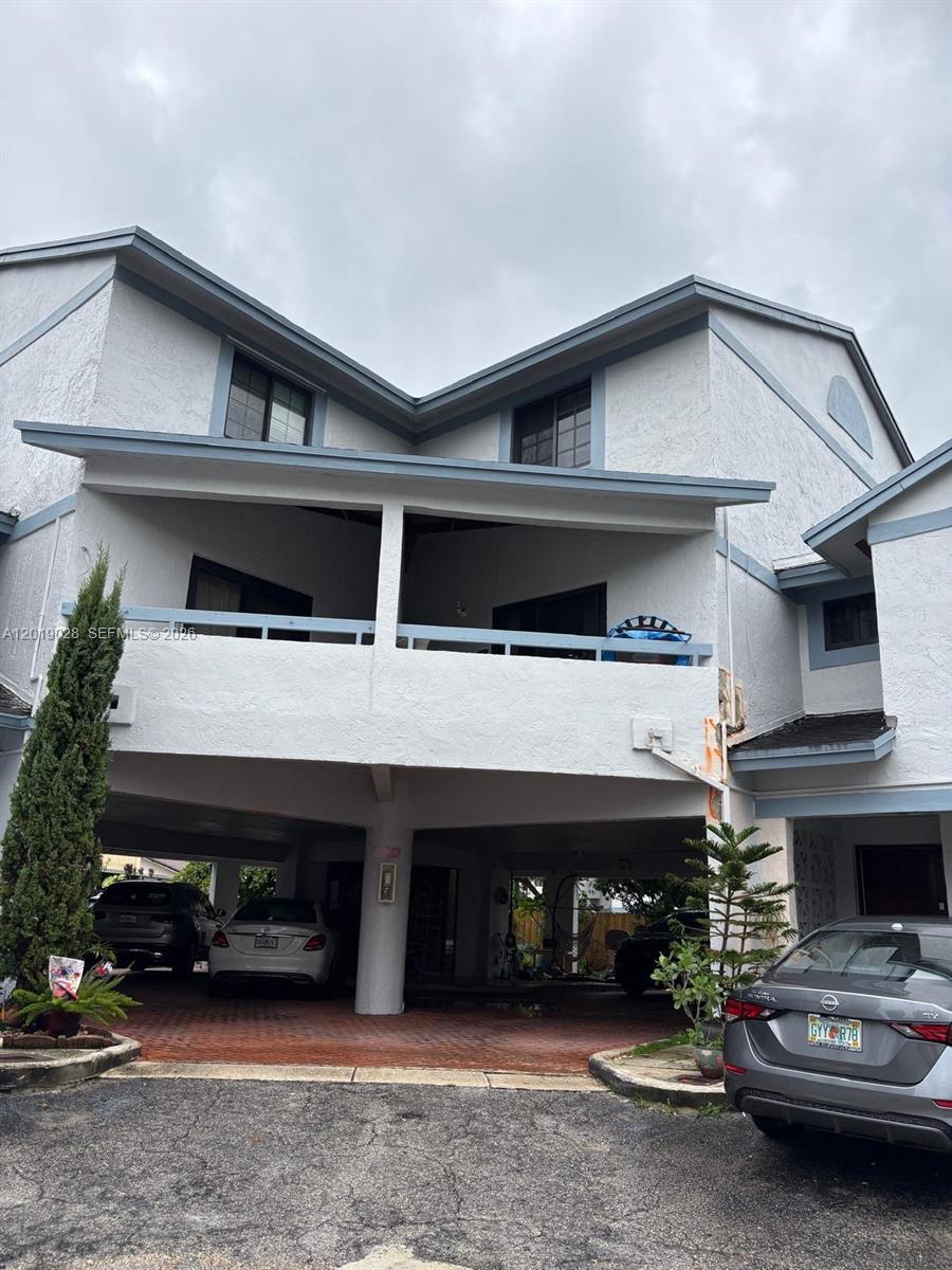 A multi-story residential building with a covered ground-level parking area and a second-floor balcony — 1405 SW 122nd Ave # 13, Miami FL 33184, MIAMI, FL