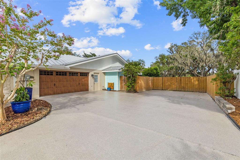 A paved driveway leads to a two-car garage with a light blue accent wall — 11310 DONNEYMOOR DRIVE, RIVERVIEW, FL