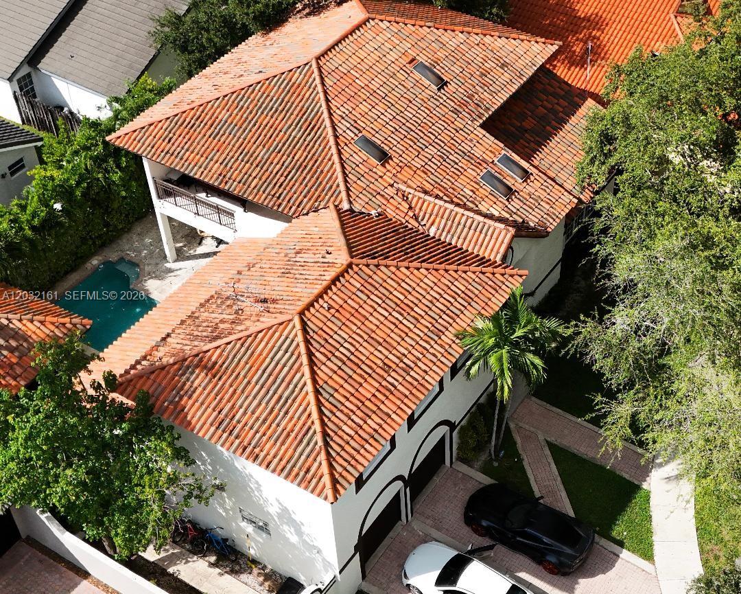 An aerial view shows a two-story house with a red tile roof and pool — 15106 NW 89th Ct, Miami Lakes FL 33018, MIAMI LAKES, FL