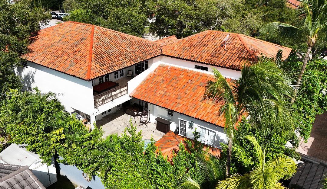 An aerial view of a two-story house with a red tile roof and patio — 15106 NW 89th Ct, Miami Lakes FL 33018, MIAMI LAKES, FL