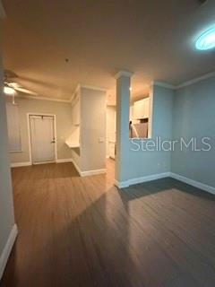 An interior view shows a room with wood-look flooring, a white door, and a kitchen pass-through — 860 N ORANGE AVENUE UNIT 146, ORLANDO, FL