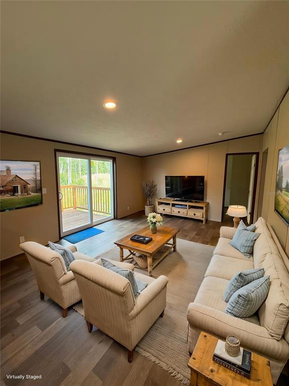 A living room features light-colored furniture, a wooden coffee table, and a sliding glass door — 4246 LA SALLE AVENUE, ST CLOUD, FL