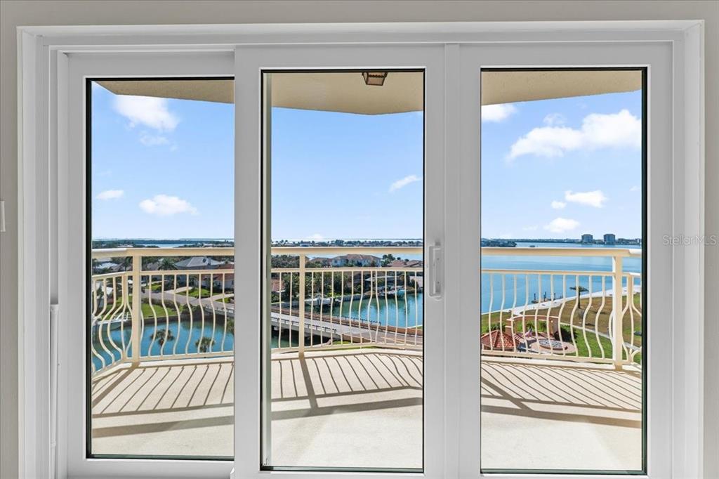 A white sliding glass door overlooks a balcony with a water view — 4900 BRITTANY DRIVE S UNIT 812, ST PETERSBURG, FL