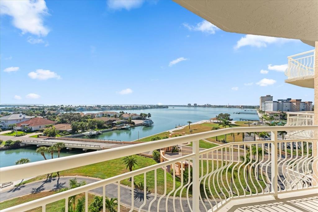 A high-angle view from a balcony overlooking a bay, a bridge, and coastal homes — 4900 BRITTANY DRIVE S UNIT 812, ST PETERSBURG, FL