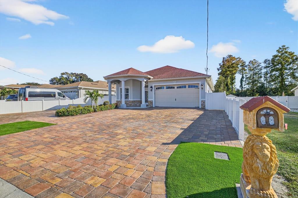 A single-story house with a paved driveway, a two-car garage, and a lion-shaped mailbox — 3914 SLIGH AVENUE, TAMPA, FL