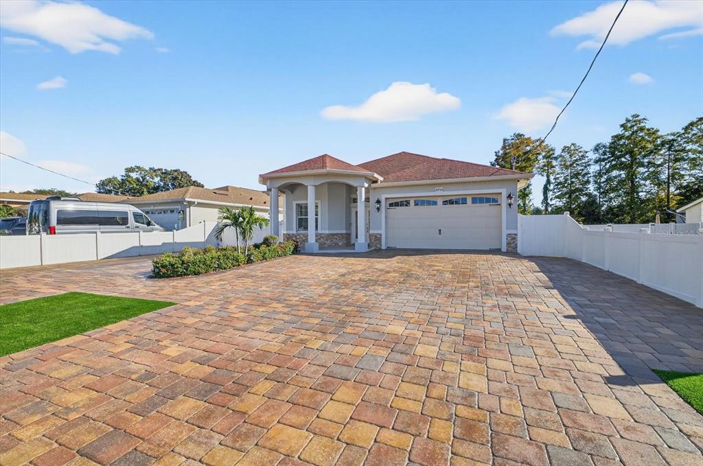 A single-story house features a large paver driveway, a two-car garage, and a covered entryway — 3914 SLIGH AVENUE, TAMPA, FL