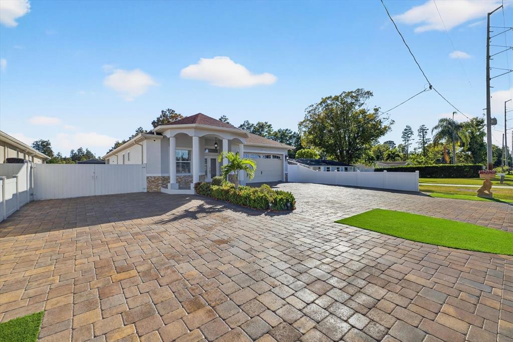 A single-story house with a paved driveway, white vinyl fencing, and a covered entryway — 3914 SLIGH AVENUE, TAMPA, FL