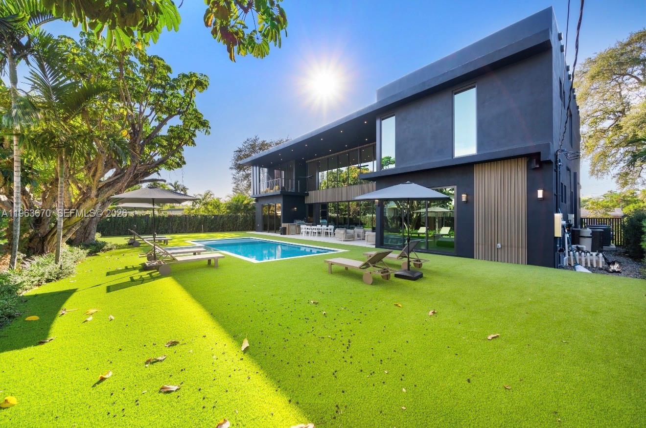 A modern two-story black house features a swimming pool and artificial turf lawn — 19701 NE 21st Ct, Miami FL 33179, MIAMI, FL