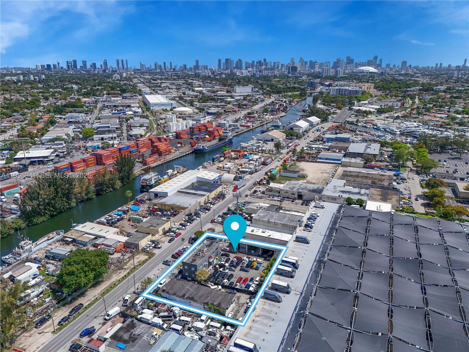 An aerial view shows a commercial property outlined in blue with a parking lot — 3326 NW South River Dr, Miami FL 33142, MIAMI, FL