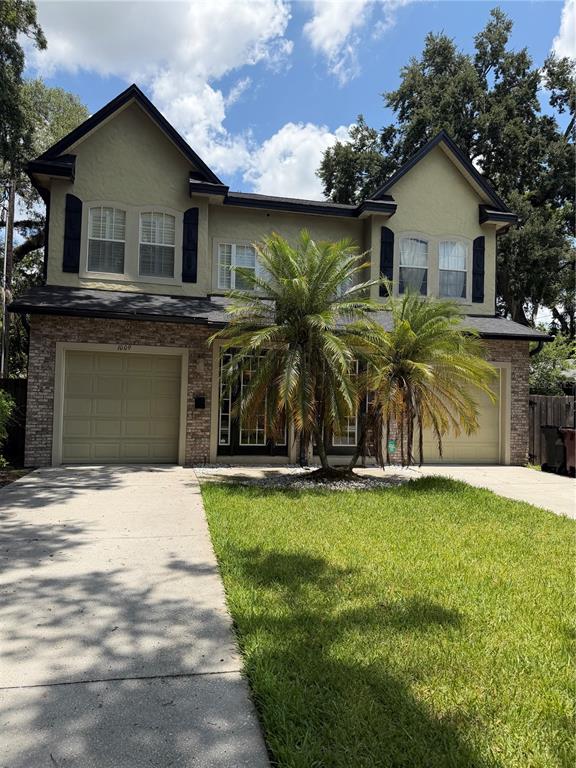 A two-story house with a brick and stucco facade, two garages, and a front palm tree — 1009 ELMWOOD STREET UNIT 1009, ORLANDO, FL