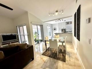 A living and dining area with tile floors, a television, and a sliding glass door — 1542 Springside Dr # 1542, Weston FL 33326, WESTON, FL