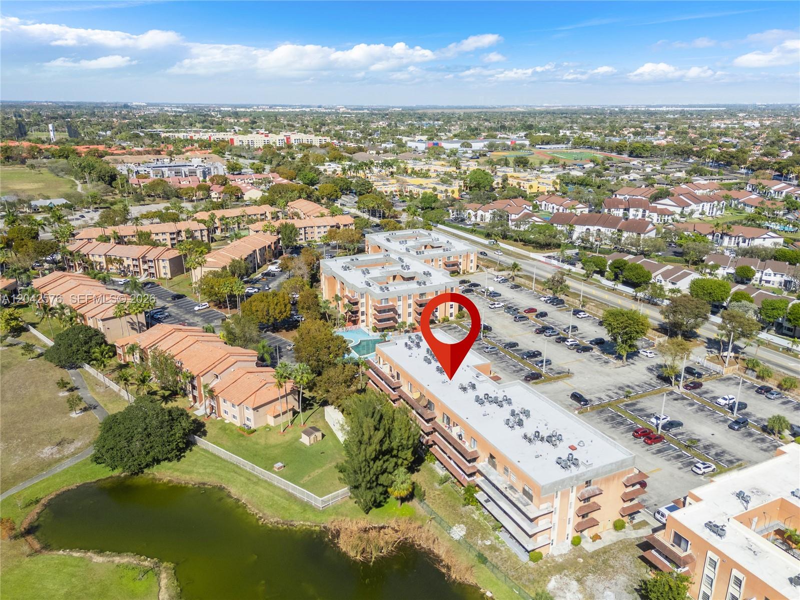An aerial view shows a multi-story apartment complex with a red location pin — 17530 NW 68th Ave # C2003, Hialeah FL 33015, HIALEAH, FL