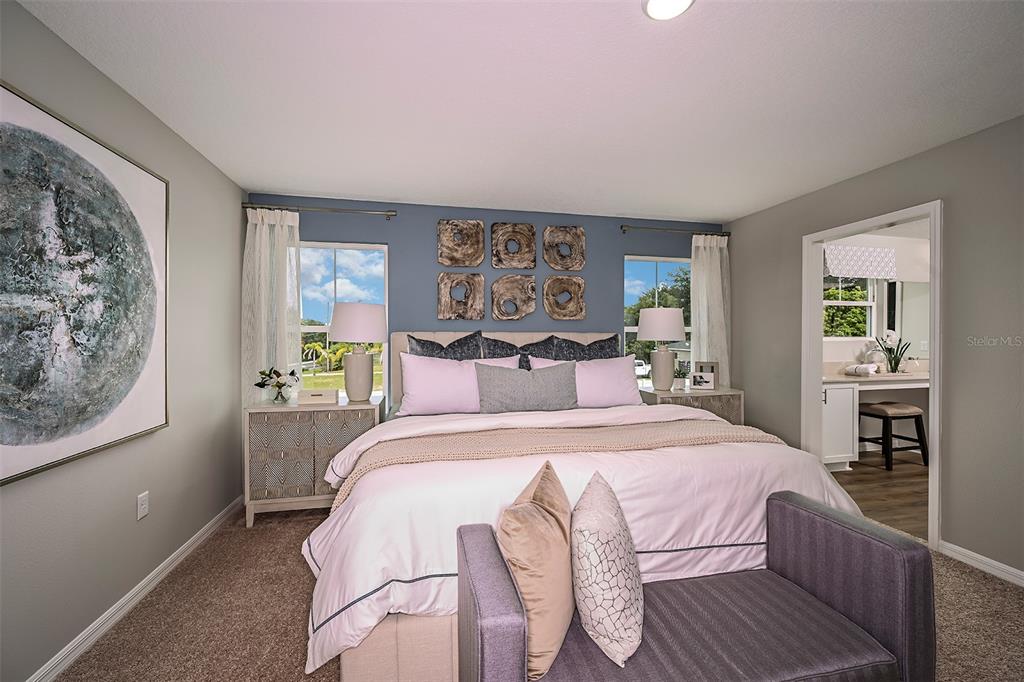 A bedroom features a blue accent wall, a king bed, and an attached bathroom — 1760 VANILLA STREET, LAKE HAMILTON, FL