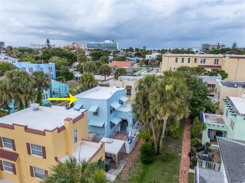 An aerial view shows a light blue two-story building with a flat roof and awnings — 4 CLARENDON COURT, DAYTONA BEACH, FL