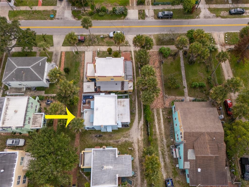 An aerial view shows several residential houses with flat roofs and palm trees — 4 CLARENDON COURT, DAYTONA BEACH, FL