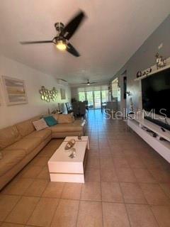 A living room with a beige sectional sofa, a white coffee table, and a ceiling fan — 1 HARBOUR LAKES UNIT 53, HUMACAO, PR