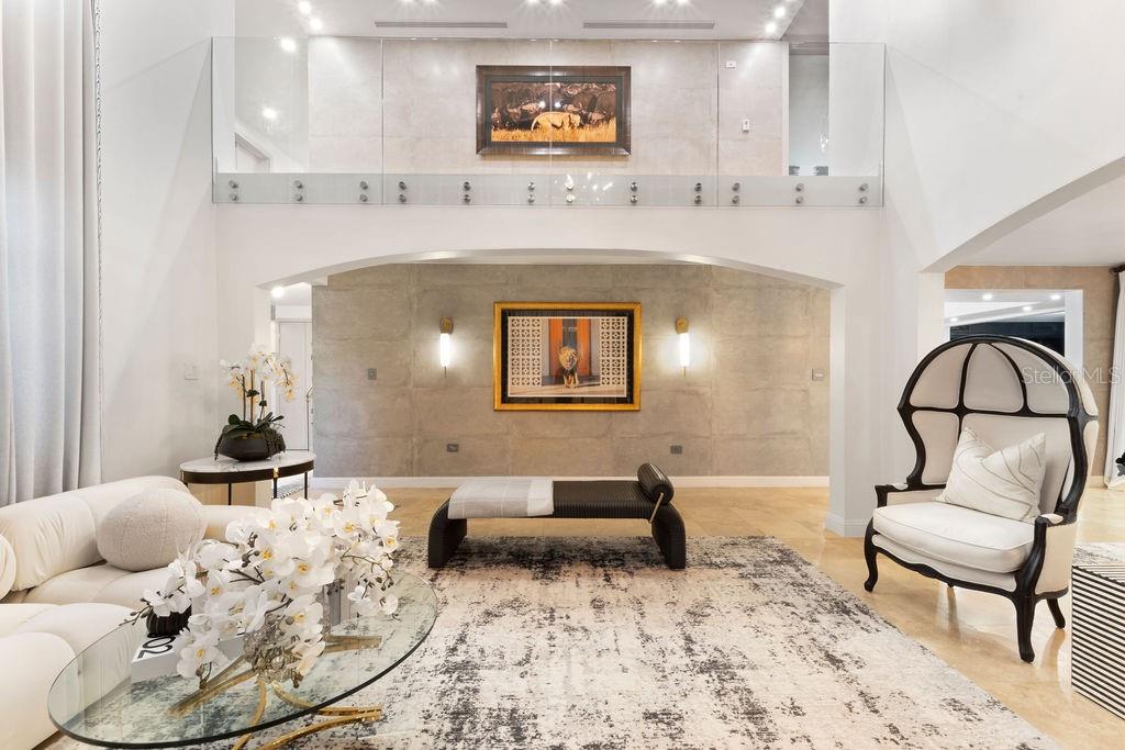 A living room with a high ceiling, glass balcony railing, and a large area rug — 386 DORADO BEACH EAST, DORADO, PR