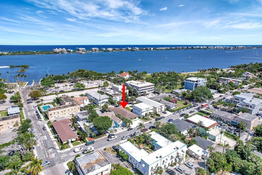 An aerial view shows a residential building marked with a red arrow near a bay — 114 S Lakeside Dr # 114, Lake Worth FL 33460, LAKE WORTH, FL