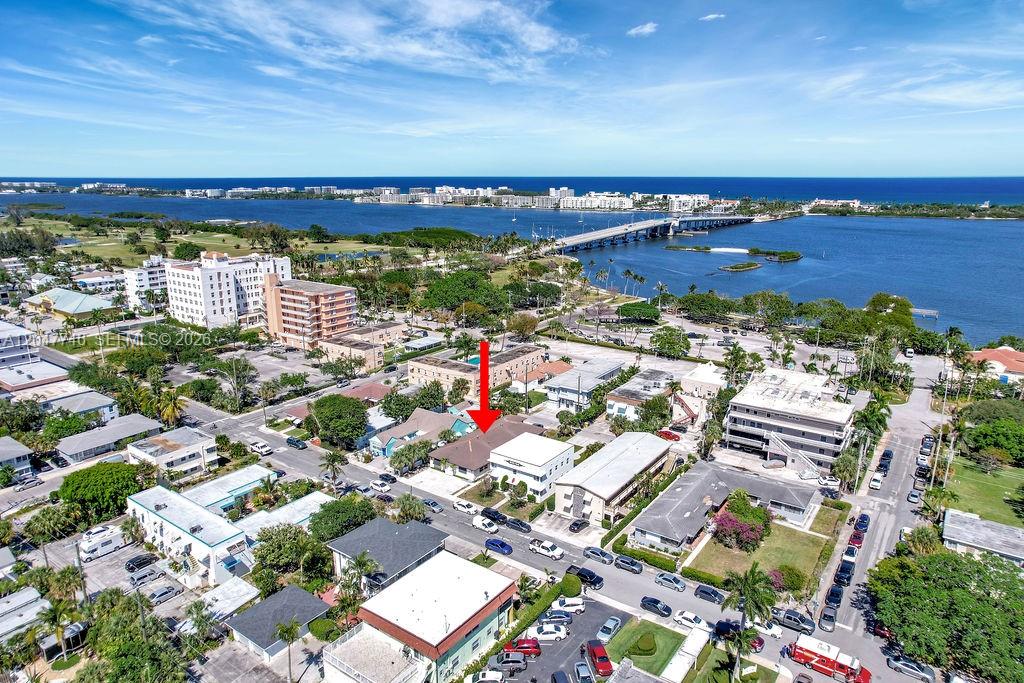 An aerial view shows a residential neighborhood with a red arrow pointing to a building — 114 S Lakeside Dr # 114, Lake Worth FL 33460, LAKE WORTH, FL