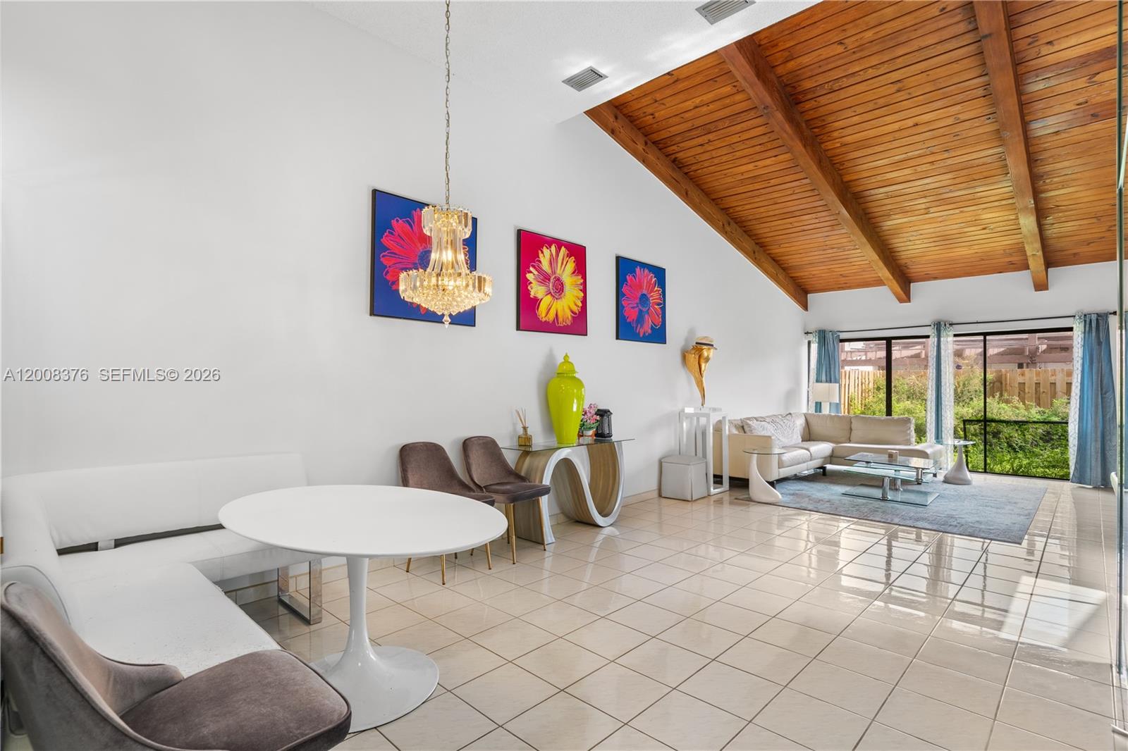 A living and dining area features a vaulted wood-plank ceiling and white tile flooring — 2679 S Parkview Dr, Hallandale Beach FL 33009, HALLANDALE BEACH, FL