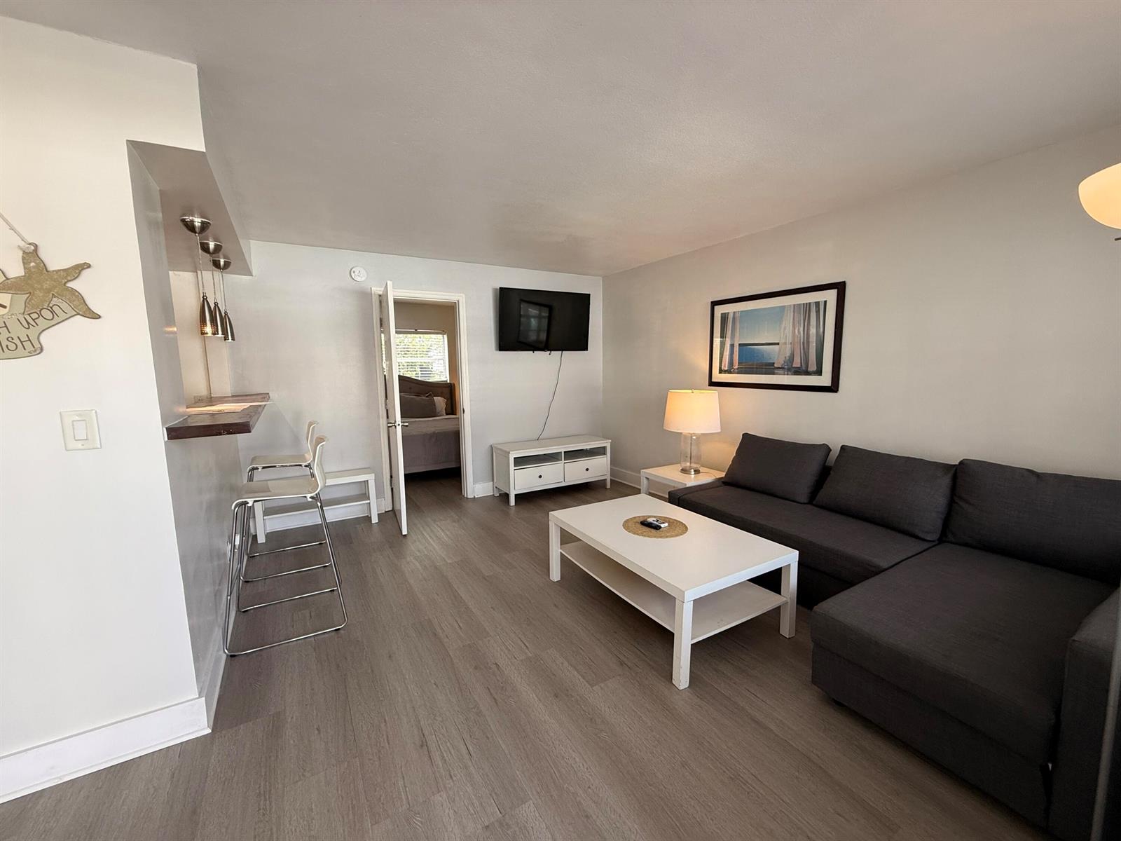 A living room features a gray sectional sofa, white coffee table, and a breakfast bar — 3226 NE 12th Street # 3, Pompano Beach FL 33062, POMPANO BEACH, FL