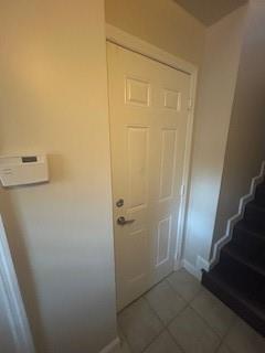 A white interior door stands next to a thermostat and a staircase with dark carpet — 2337 Vintage Drive, Lighthouse Point FL 33064, LIGHTHOUSE POINT, FL