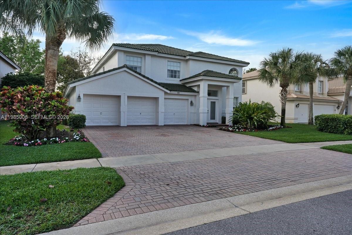 A two-story house with a three-car garage and a brick paver driveway — 4202 Bahia Isle Cir, Wellington FL 33449, WELLINGTON, FL