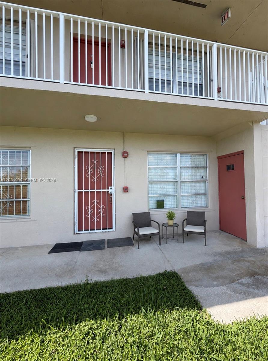 A kitchen features honey-oak cabinets, dark countertops, stainless steel appliances, and white tile flooring — 12860 SW 43rd Dr # B, Miami FL 33175, MIAMI, FL