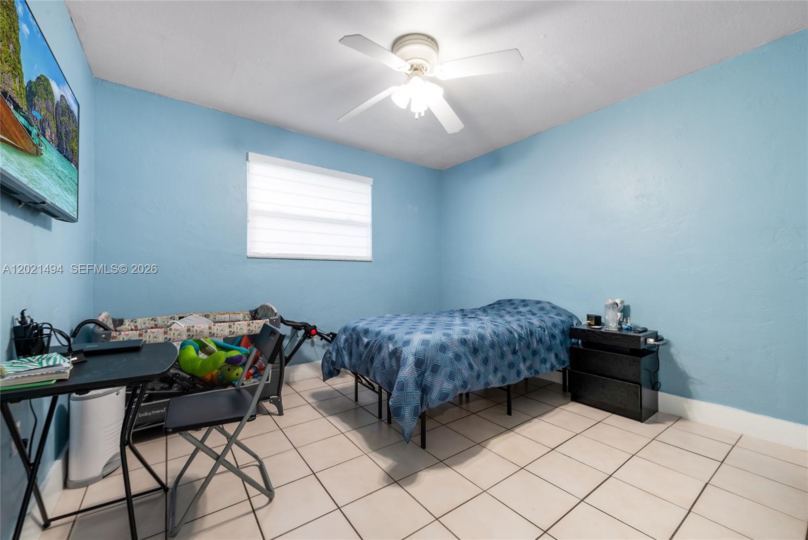 A bedroom with light blue walls, tile flooring, a ceiling fan, and a single bed — 4655 Palm Ave # 332, Hialeah FL 33012, HIALEAH, FL