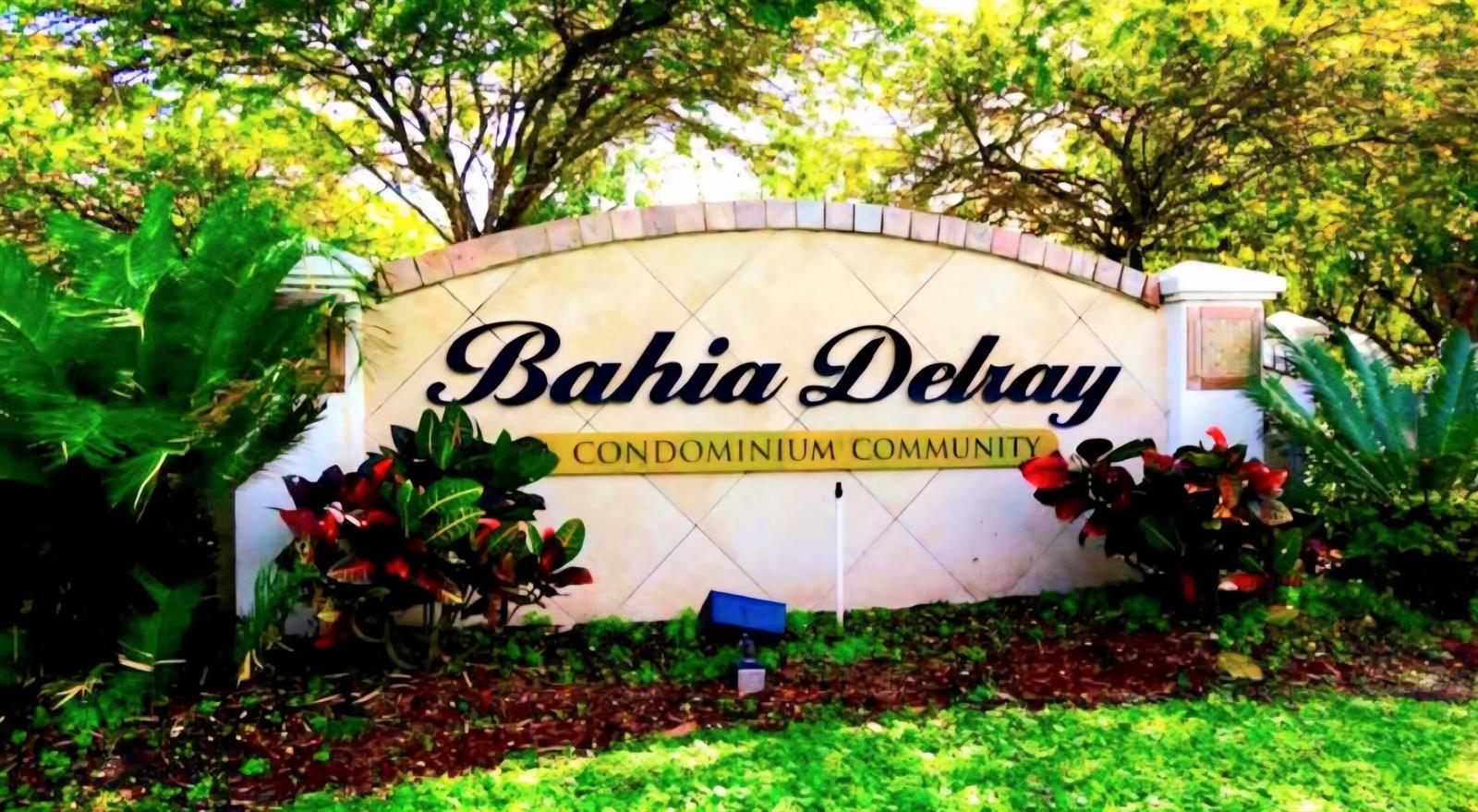 A stone sign for the Bahia Delray Condominium Community surrounded by lush tropical landscaping — 1020 Crystal Way # C, Delray Beach FL 33444, DELRAY BEACH, FL