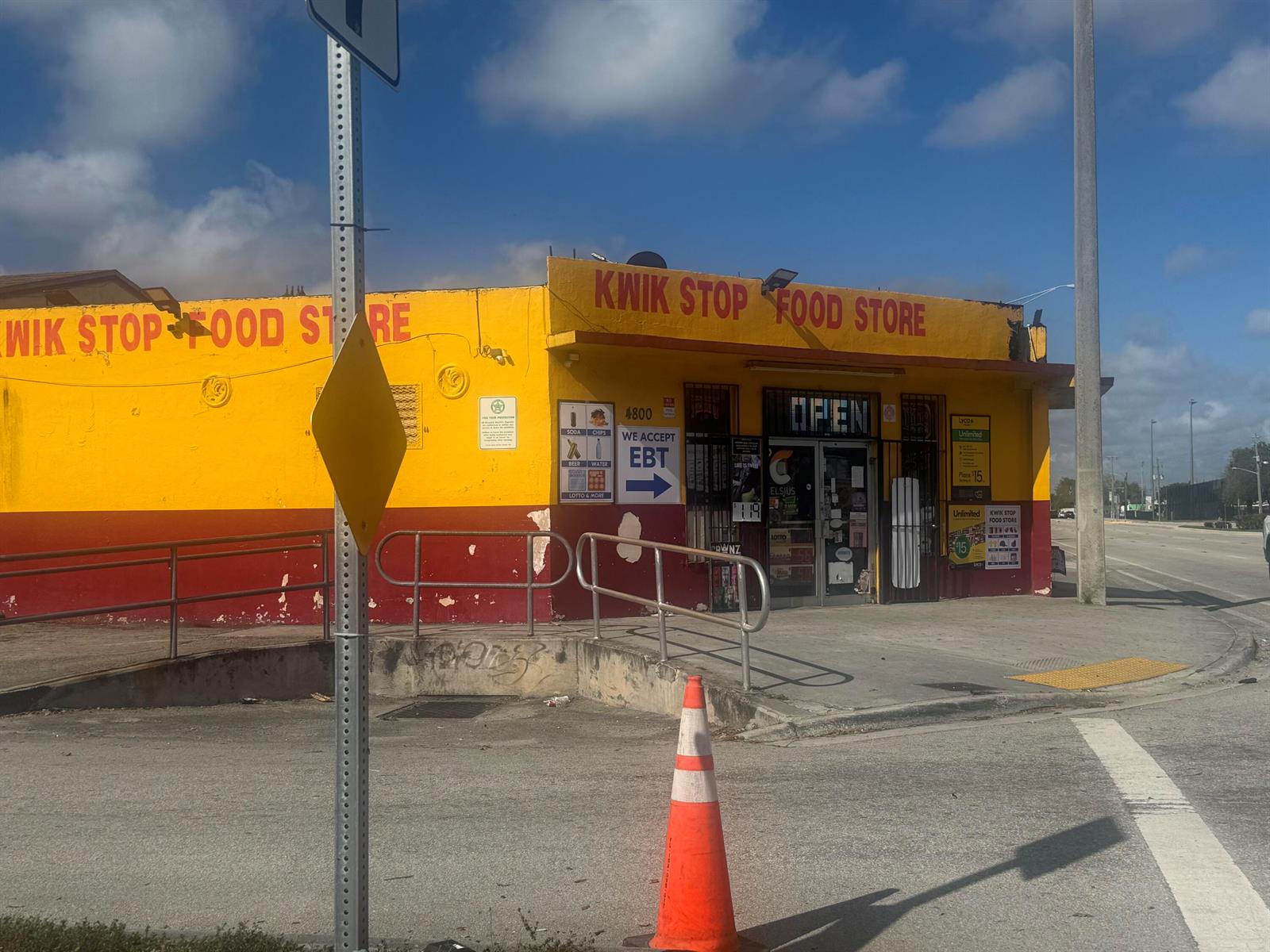 A yellow and red corner convenience store building stands next to a road with a cone — 4800 Pembroke Road, West Park FL 33021, WEST PARK, FL