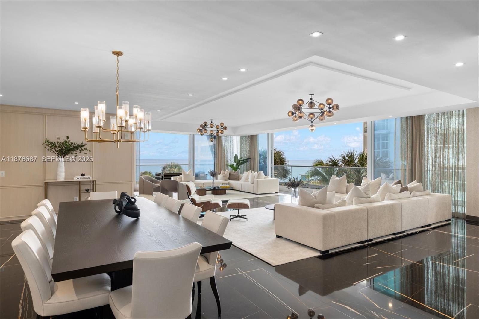 A spacious living and dining area features dark marble floors, white sofas, and ocean views — 9349 Collins Ave # 406, Surfside FL 33154, SURFSIDE, FL